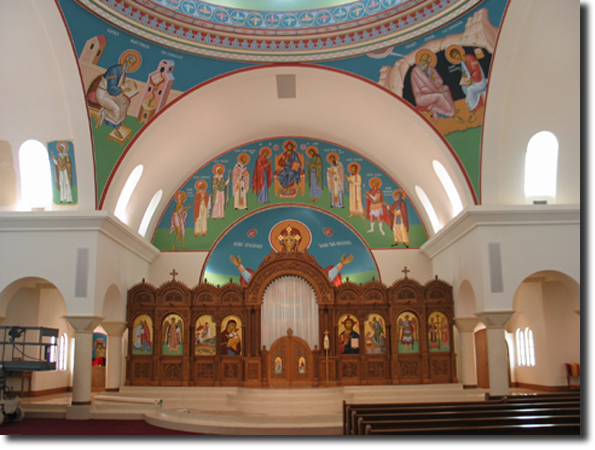 A view of the iconastasis. You can also see an icon in the process of
    being installed in the north apse.